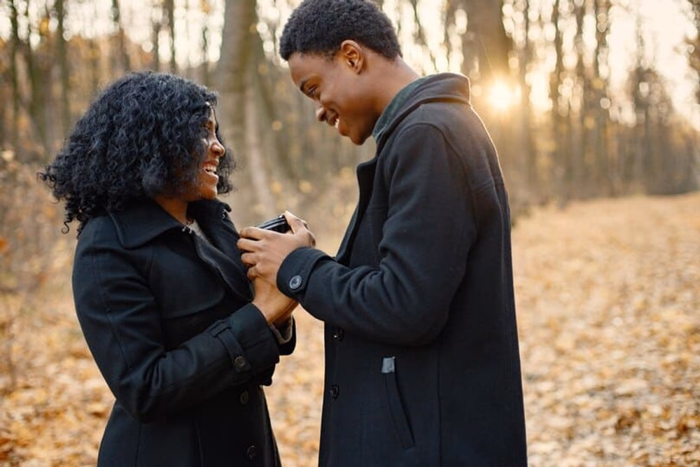 black-young-man-his-girlfriend-holding-hands-one-coffee-cup-romantic-couple-walking-autumn-park-man-woman-wearing-black-coats